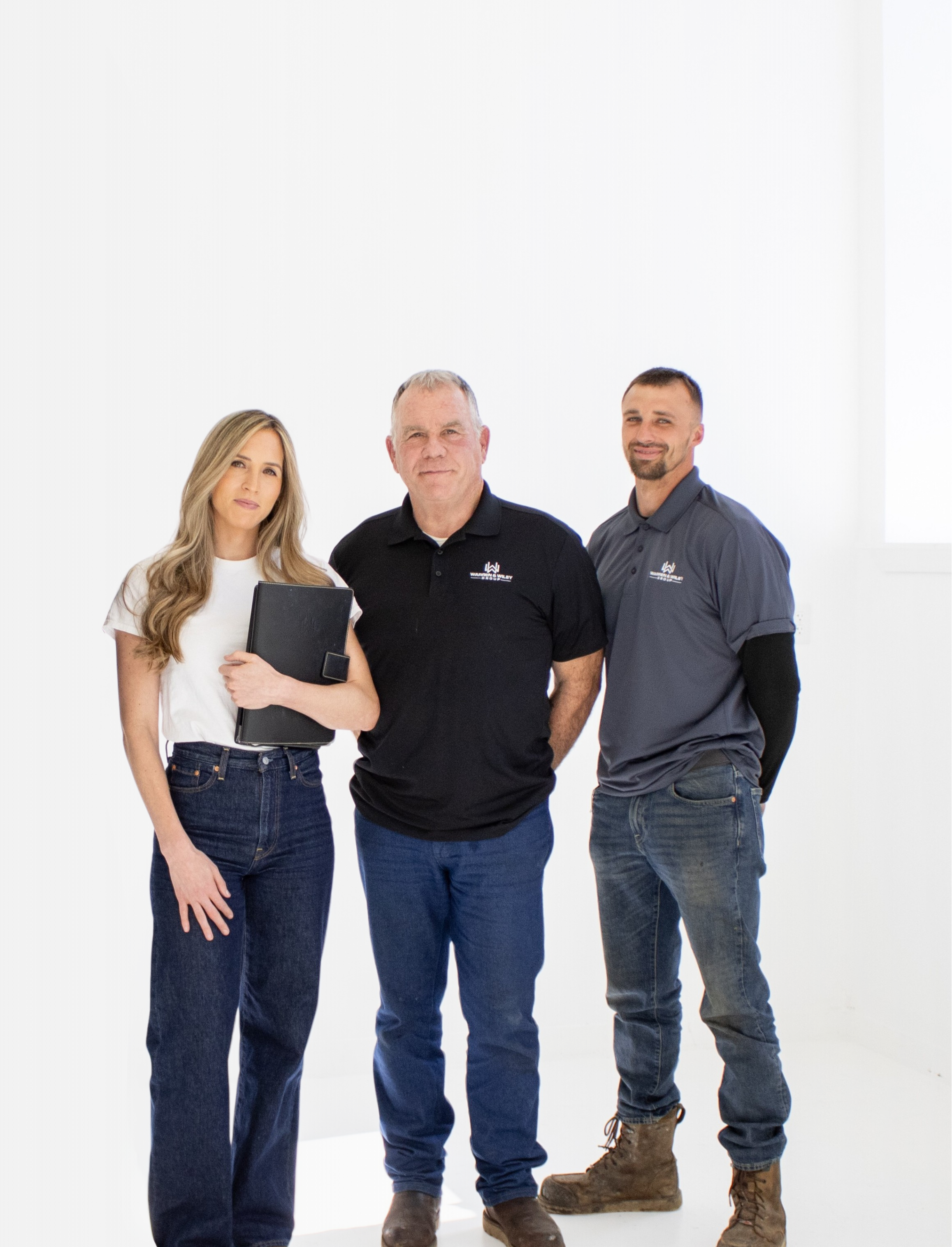 Three people standing together on a white background