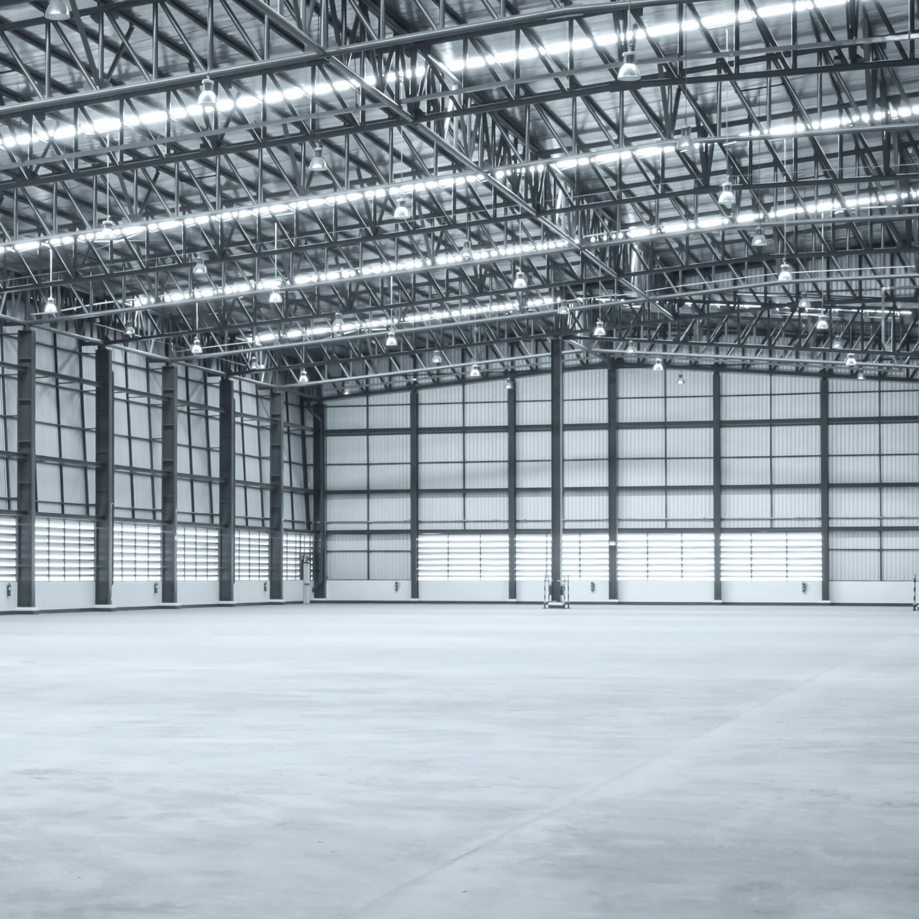 Large industrial warehouse with high ceilings and large doors.
